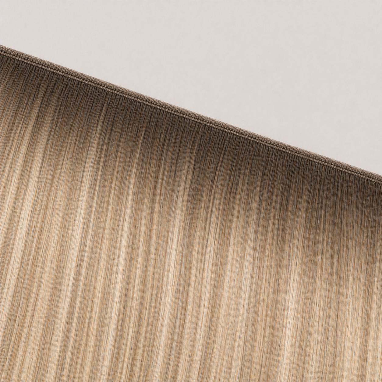 Flat butterfly weft seam of Stessia hair extensions in shade #10/24 Balayage