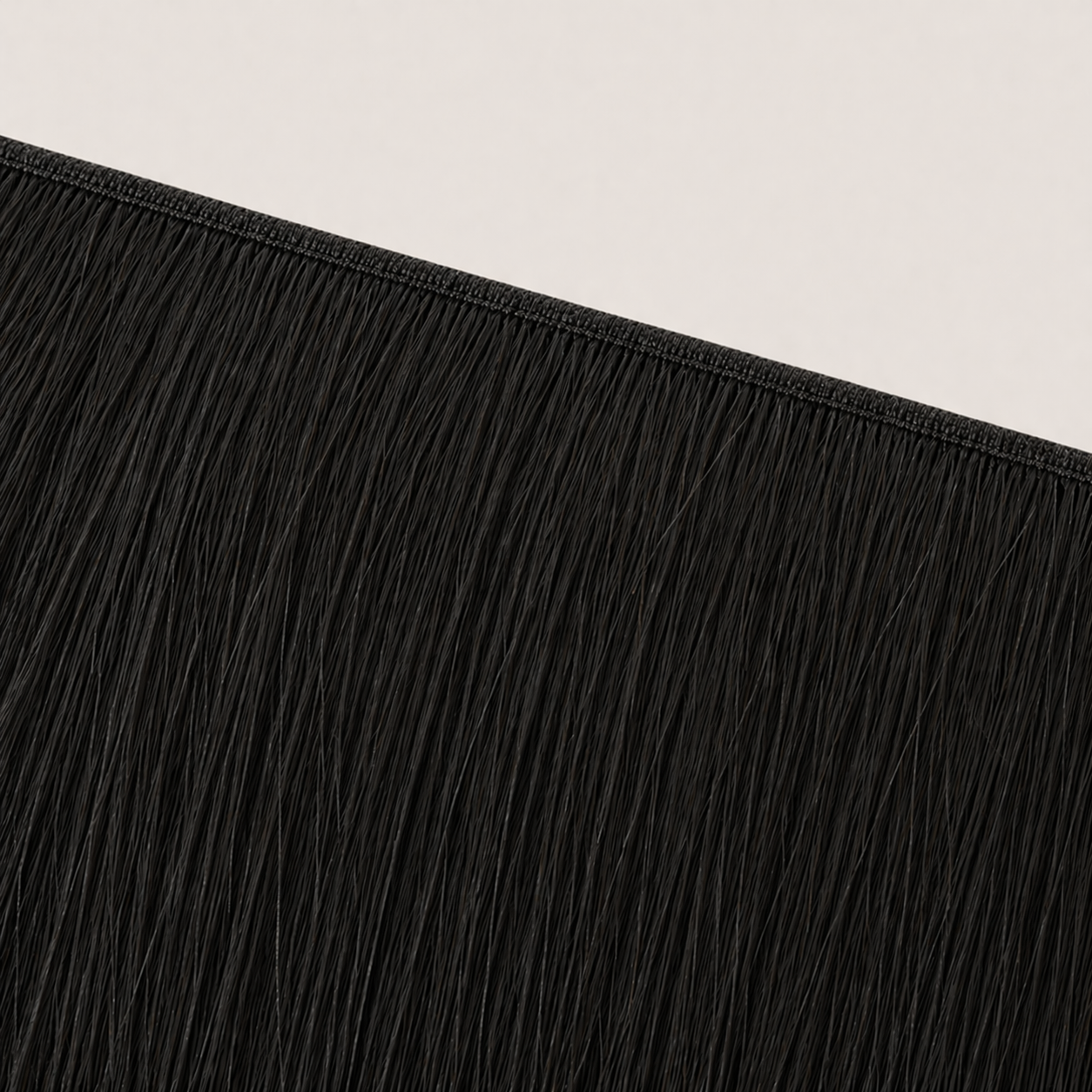 Flat butterfly weft seam of Stessia hair extensions in shade #1A Natural Black