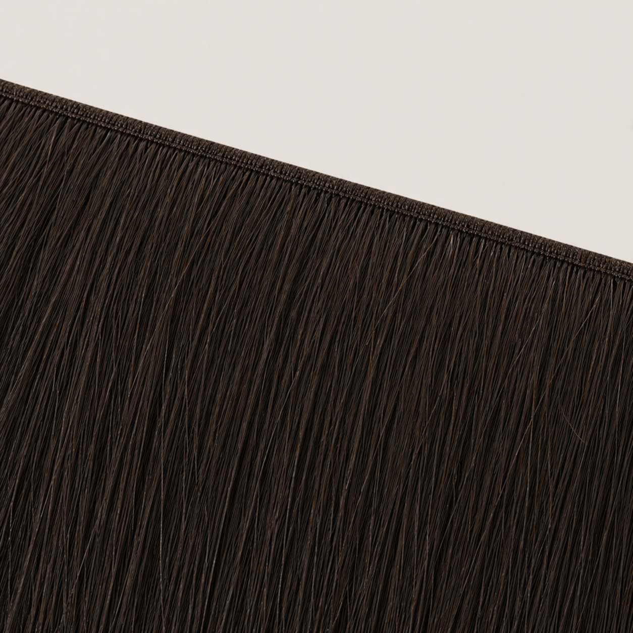 Flat butterfly weft seam of Stessia hair extensions in shade #2 Black Brown