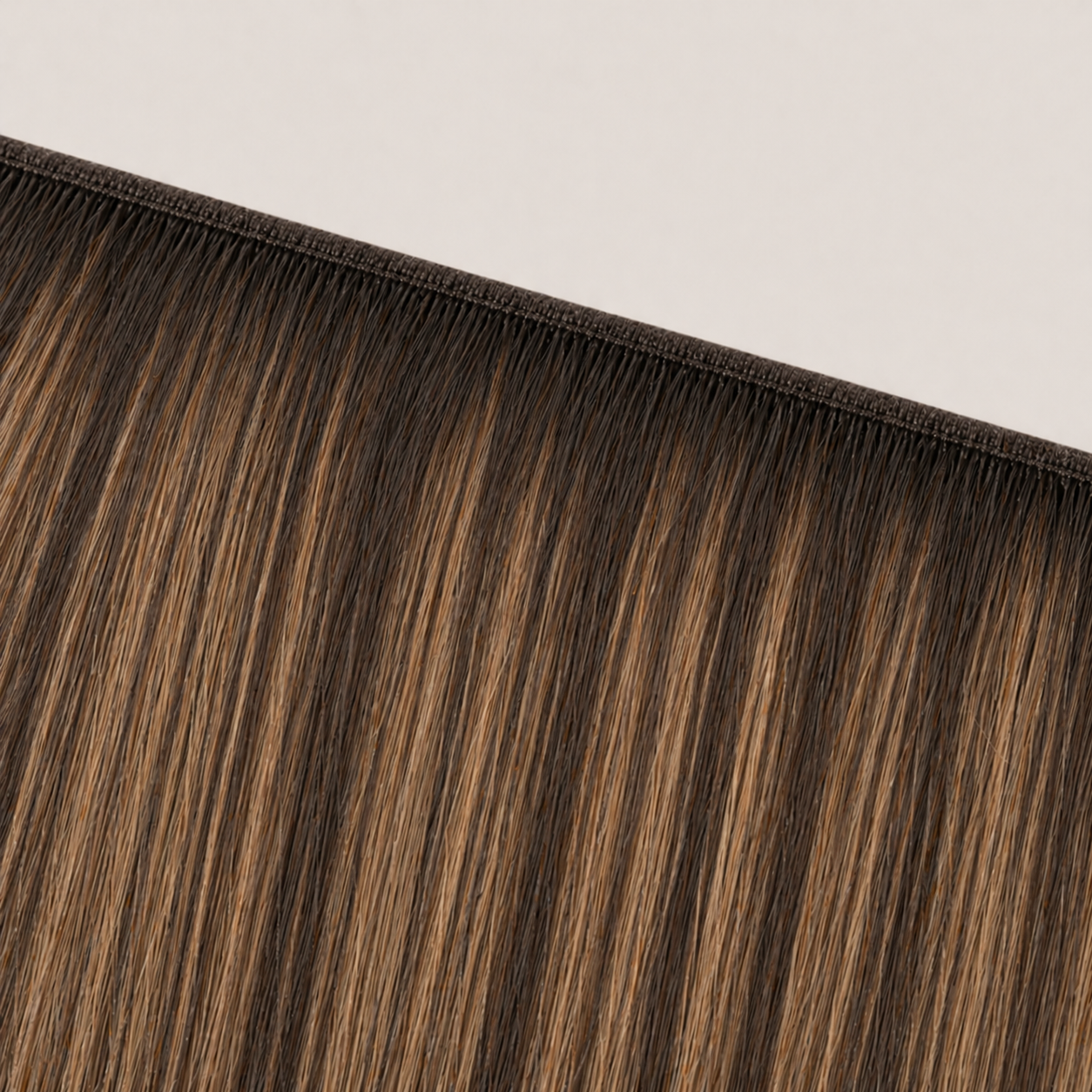 Flat butterfly weft seam of Stessia hair extensions in shade #3T8/613 Balayage