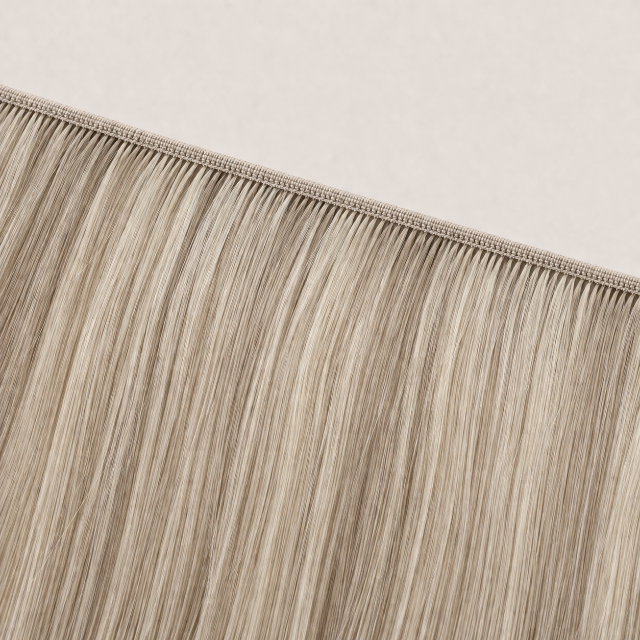 Flat butterfly weft seam of Stessia hair extensions in shade #613/18A Highlights