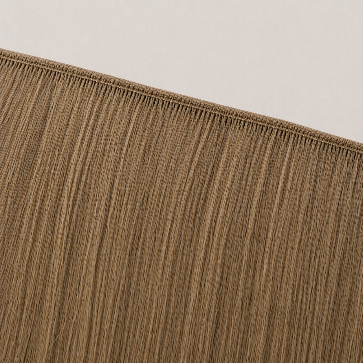 Flat butterfly weft seam of Stessia hair extensions in shade #8 Medium Blonde