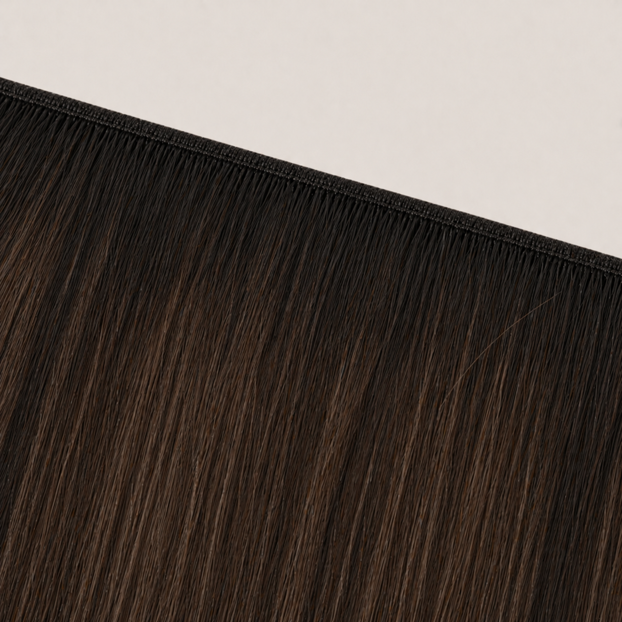 Flat butterfly weft seam of Stessia hair extensions in shade #1BT/2/4 Balayage