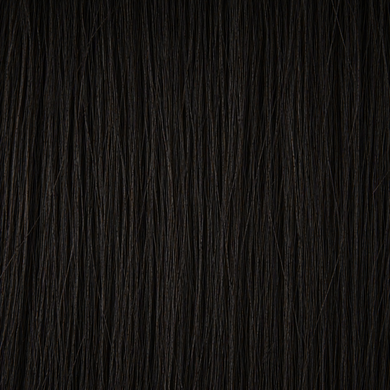 Close-up of the Remy human hair texture in shade #1B Brown Black