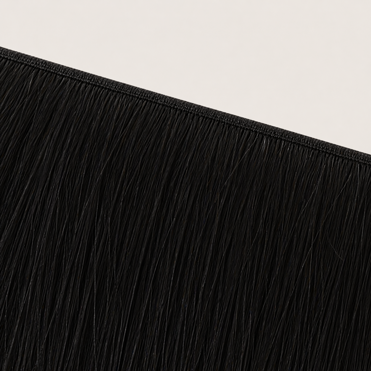 Flat butterfly weft seam of Stessia hair extensions in shade #1 Jet Black