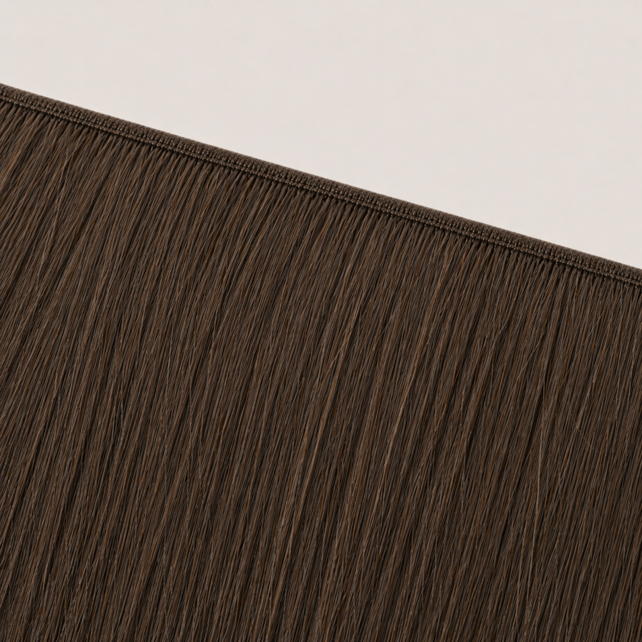 Flat butterfly weft seam of Stessia hair extensions in shade #3 Dark Brown