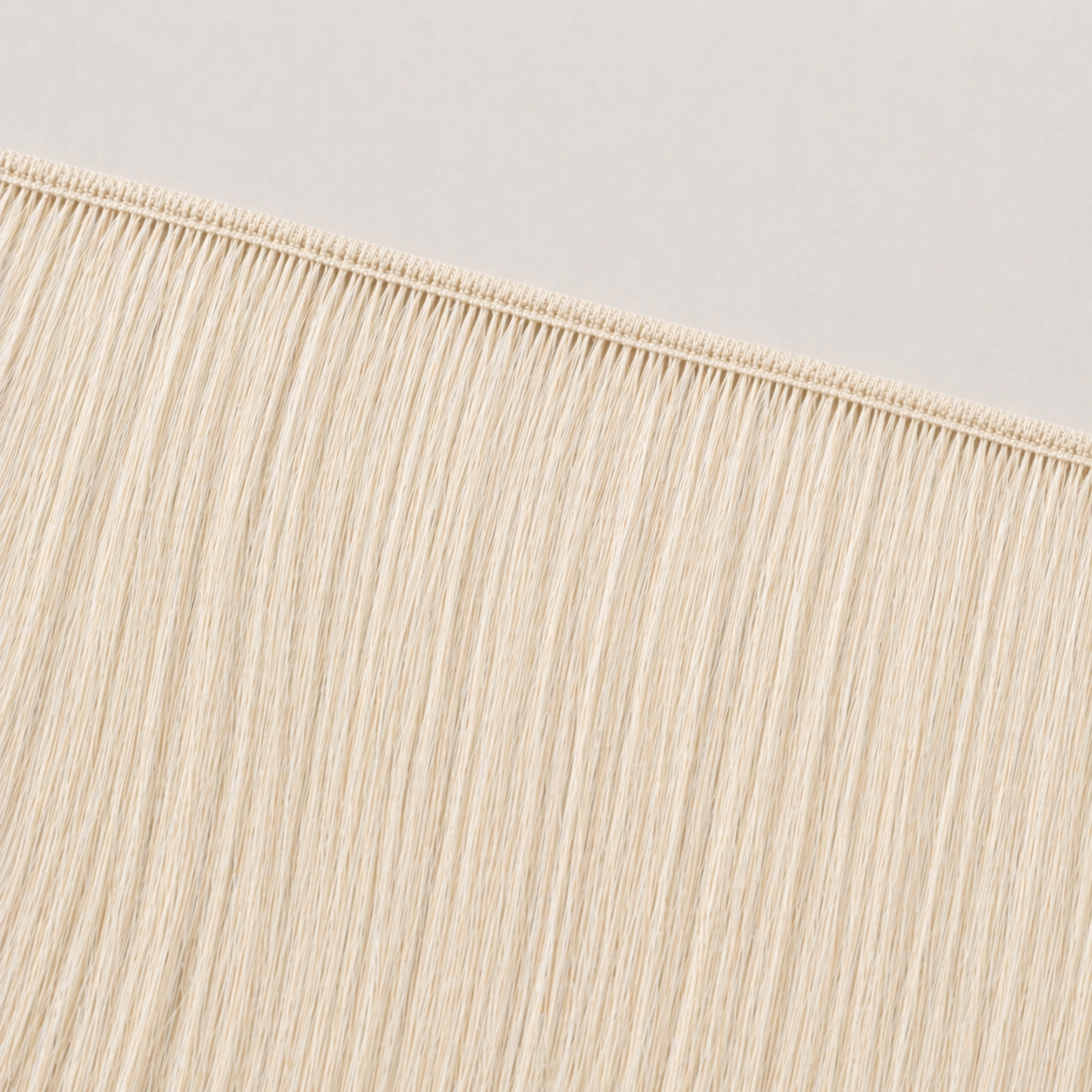 Flat butterfly weft seam of Stessia hair extensions in shade #60 Platinum Blonde