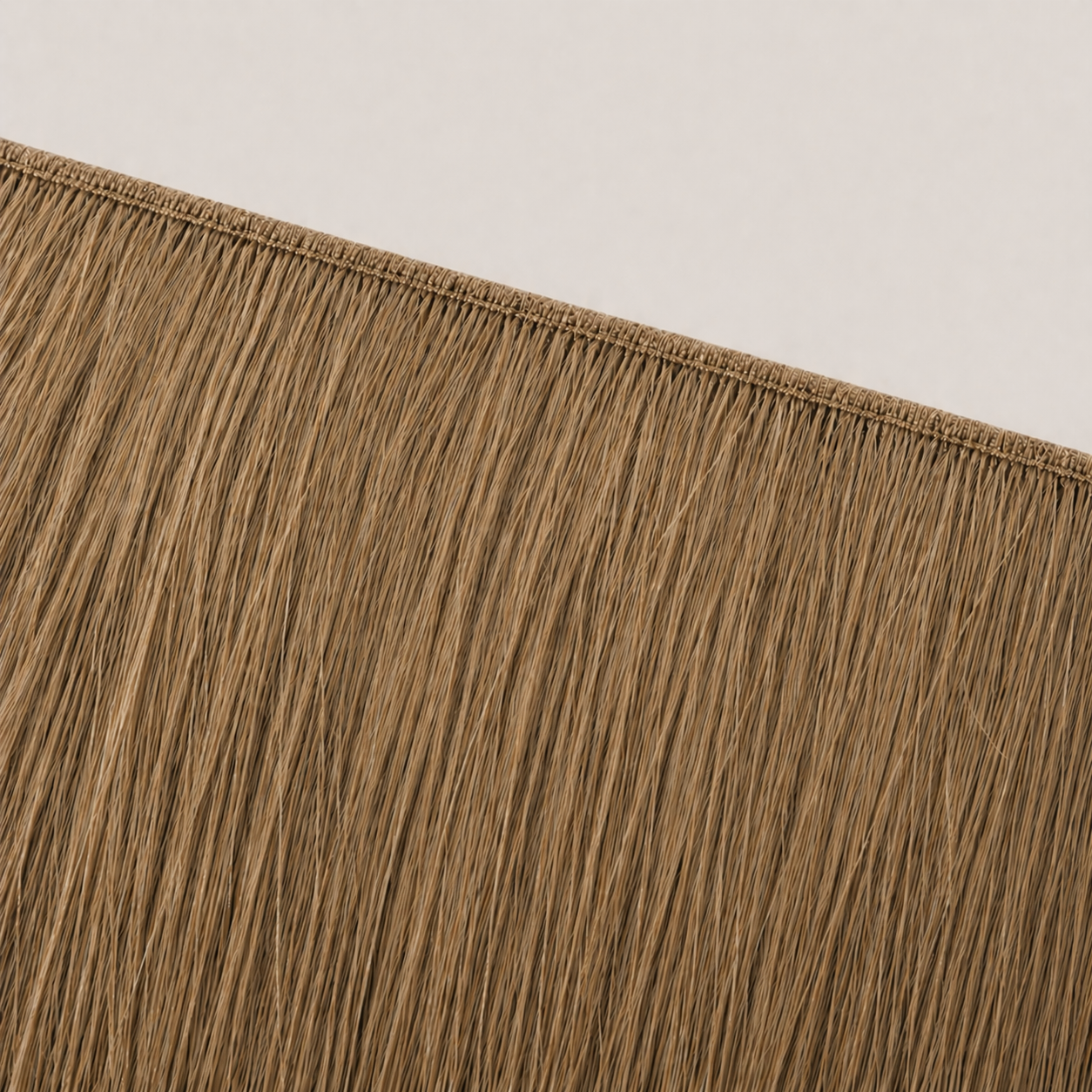 Flat butterfly weft seam of Stessia hair extensions in shade #6 Dark Blonde