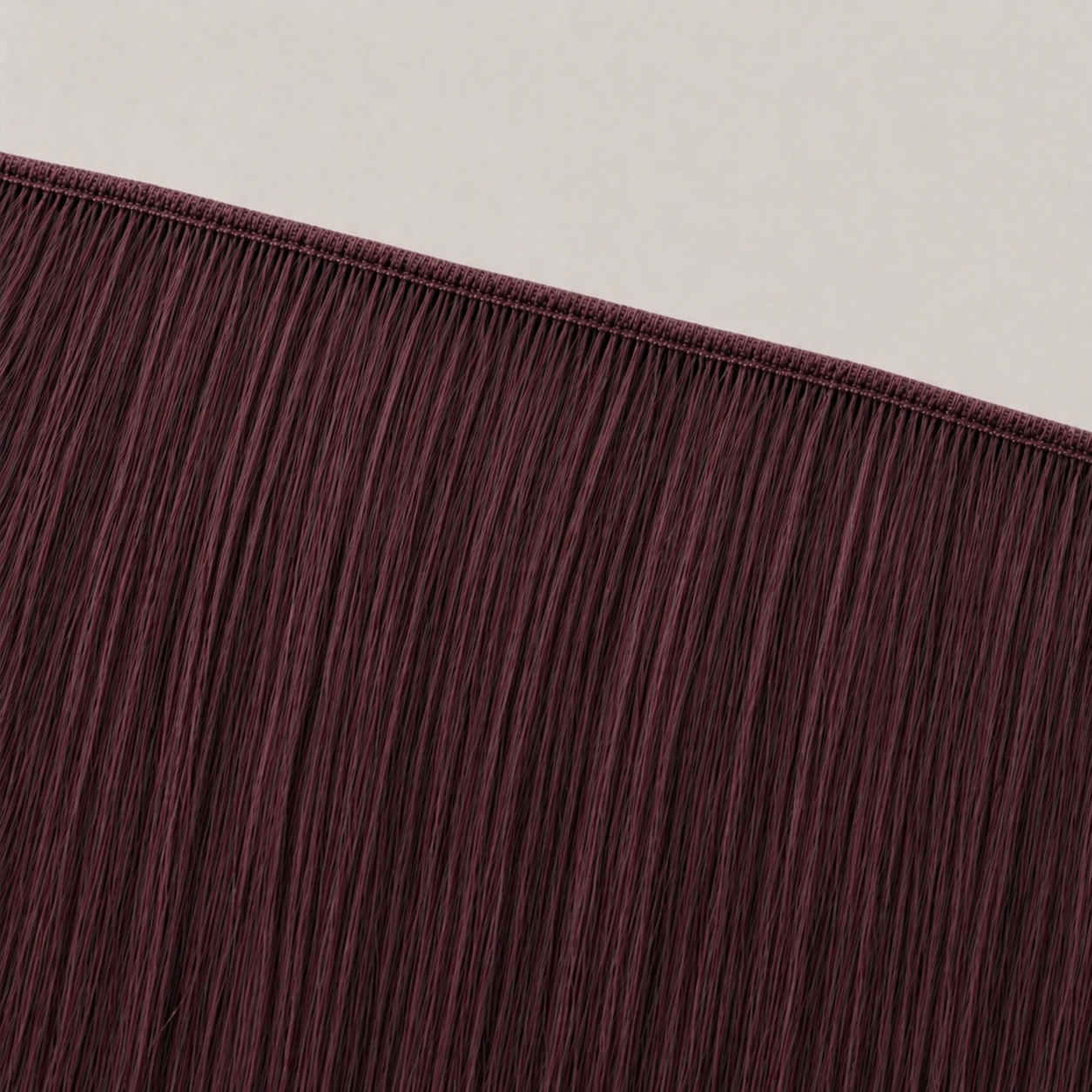 Flat butterfly weft seam of Stessia hair extensions in shade #99J Burgundy